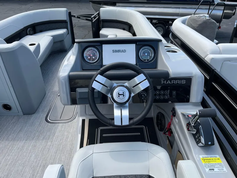 Slide: The Image of 2026 Harris Solstice 250 boat dashboard with steering wheel and control panel. - 6