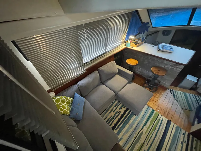 Slide: The Image of Interior of 1992 Carver 33 Aft Cabin MY with cozy seating and nautical decor. - 12