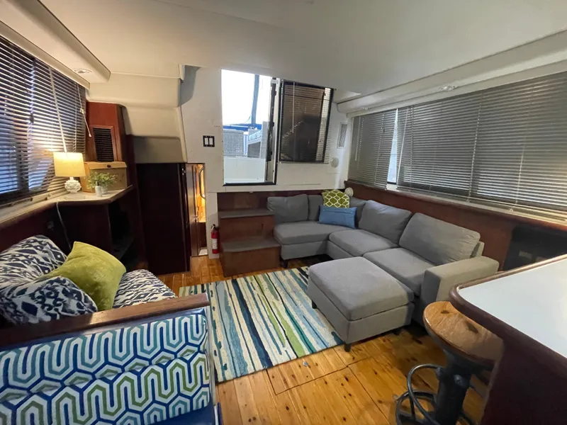 Slide: The Image of Luxurious 1992 Carver 33 Aft Cabin MY interior with cozy seating and stylish decor. - 13