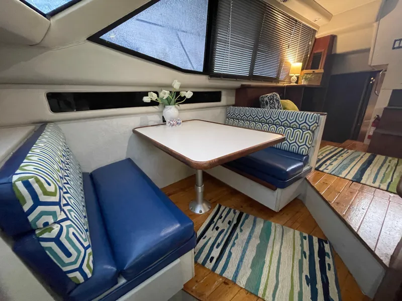 Slide: The Image of 1992 Carver 33 Aft Cabin MY interior with cozy dining area and stylish decor. - 14