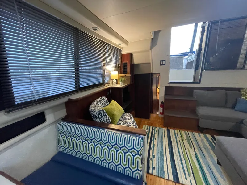 Slide: The Image of Interior of 1992 Carver 33 Aft Cabin MY with cozy seating and striped rug. - 15