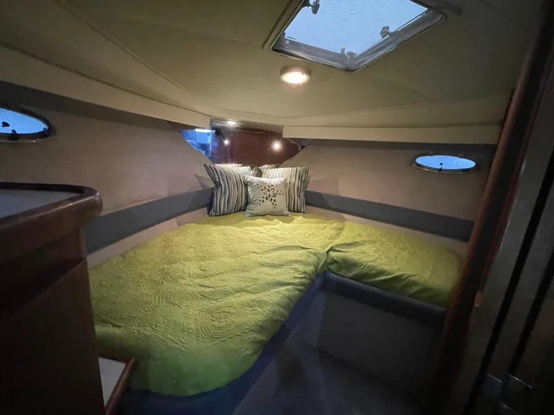 Slide: The Image of Cozy cabin interior of 1992 Carver 33 Aft Cabin MY with green bedding and portholes. - 16
