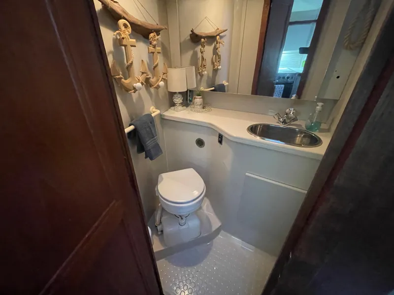 Slide: The Image of 1992 Carver 33 Aft Cabin MY bathroom with nautical decor, sink, and toilet. - 18