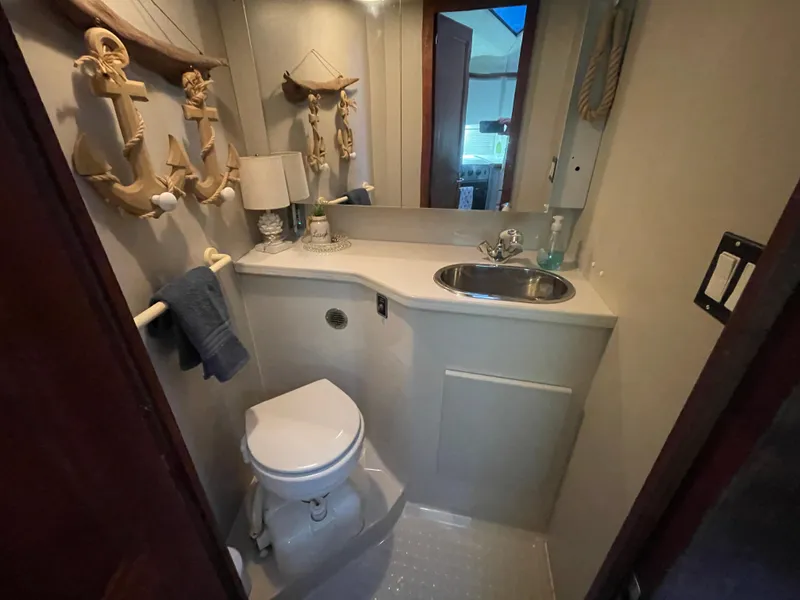 Slide: The Image of 1992 Carver 33 Aft Cabin MY bathroom with nautical decor, sink, and toilet. - 19