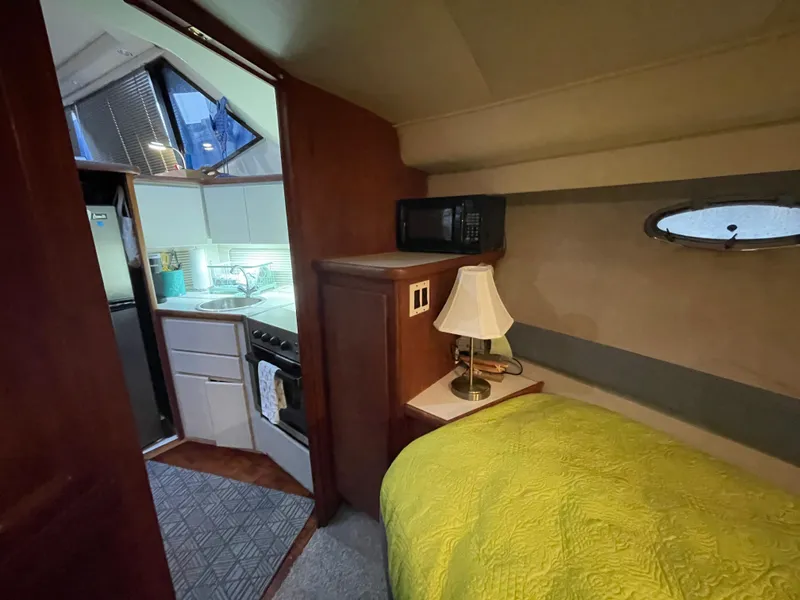Slide: The Image of 1992 Carver 33 Aft Cabin MY interior with cozy bedroom and compact kitchen. - 20