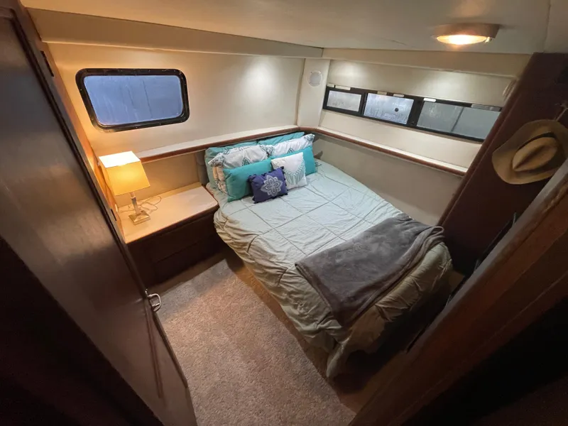 Slide: The Image of Cozy bedroom in 1992 Carver 33 Aft Cabin MY with bed, lamp, and window. - 24