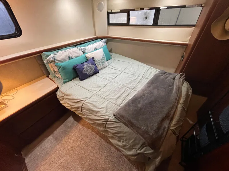 Slide: The Image of Cozy bedroom in 1992 Carver 33 Aft Cabin MY with plush bedding and soft lighting. - 25