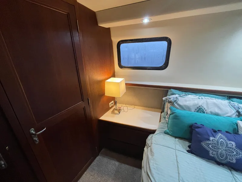 Slide: The Image of Cozy bedroom in 1992 Carver 33 Aft Cabin MY with lamp and window. - 26