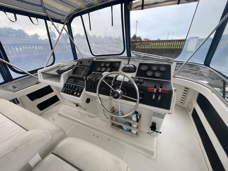 Slide: The Image of 1992 Carver 33 Aft Cabin MY helm with steering wheel and control panel. - 32