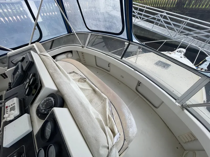 Slide: The Image of Interior of 1992 Carver 33 Aft Cabin MY with helm and seating area. - 35