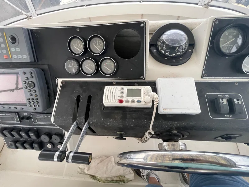 Slide: The Image of 1992 Carver 33 Aft Cabin MY helm with navigation controls and gauges. - 37