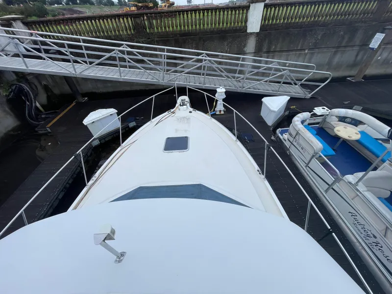 Slide: The Image of 1992 Carver 33 Aft Cabin MY docked, viewed from above, with adjacent boats and walkway. - 39