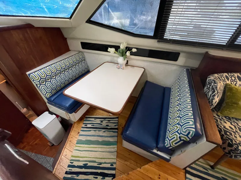 Slide: The Image of Interior of 1992 Carver 33 Aft Cabin MY with cozy dining area and patterned seating. - 40