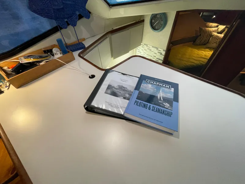 Slide: The Image of 1992 Carver 33 Aft Cabin MY interior with seamanship book on table. - 42