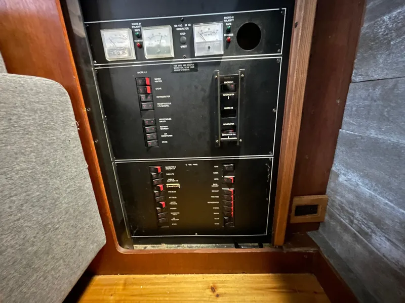 Slide: The Image of Electrical panel of 1992 Carver 33 Aft Cabin MY boat, featuring switches and meters. - 43