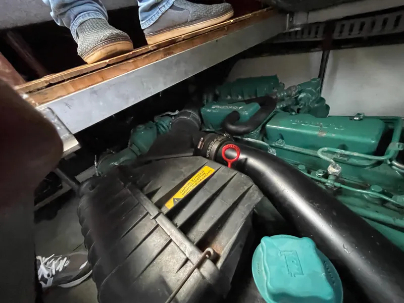 Slide: The Image of Engine compartment of a 1992 Carver 33 Aft Cabin MY boat, showing mechanical components. - 47