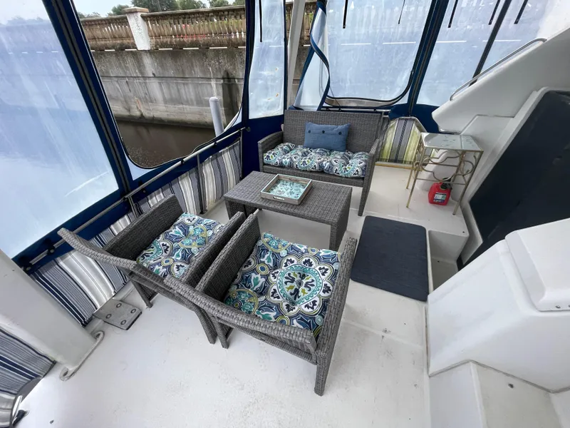 Slide: The Image of 1992 Carver 33 Aft Cabin MY interior with wicker seating and patterned cushions. - 7