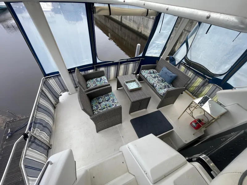 Slide: The Image of 1992 Carver 33 Aft Cabin MY with cozy outdoor seating and stylish decor. - 8