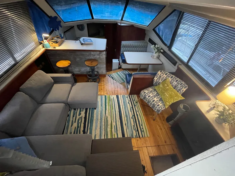 Slide: The Image of Interior of 1992 Carver 33 Aft Cabin MY with cozy seating and nautical decor. - 9