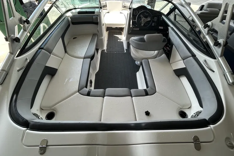 Slide: The Image of 2013 Yamaha Boats 212 X interior with spacious seating and modern dashboard. - 3