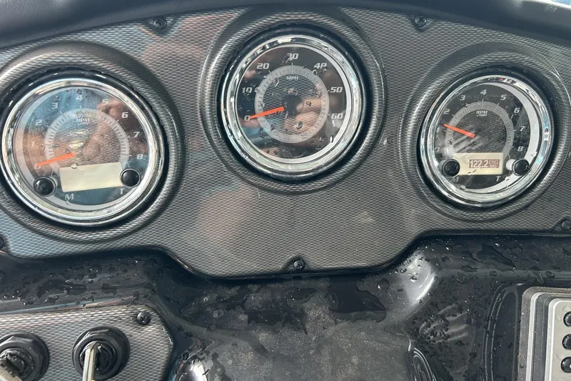 Slide: The Image of Dashboard of a 2013 Yamaha Boats 212 X with speedometer and tachometer gauges. - 8