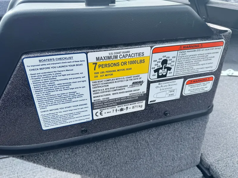 Slide: The Image of 2023 Ranger VX1888 WT boat interior with gray and red seat, cup holders, and storage compartment. - 11