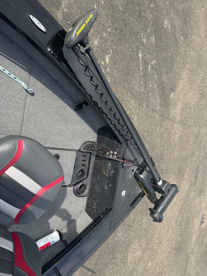 Slide: The Image of 2023 Ranger VX1888 WT boat interior with gray and red seating, fishing rod holders, and storage compartments. - 12