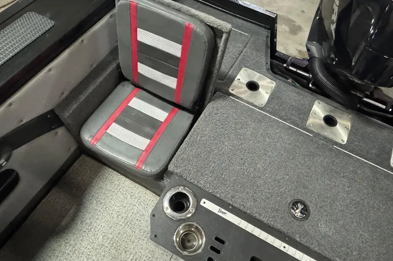 Slide: The Image of 2023 Ranger VX1888 WT boat storage compartment with measuring ruler and secure latch. - 14