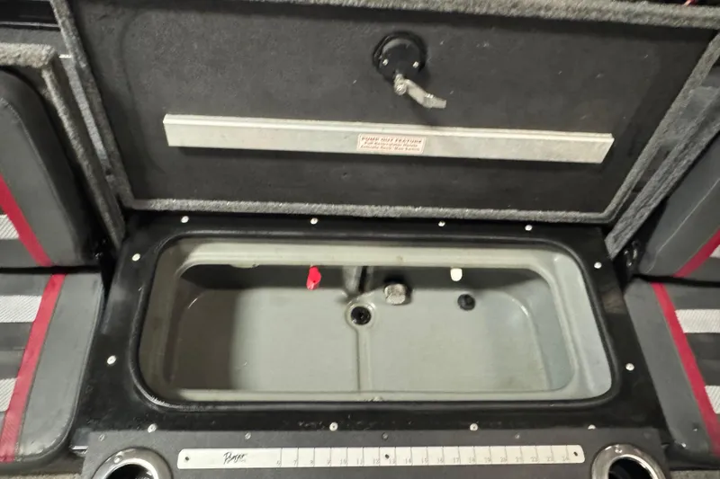 Slide: The Image of 2023 Ranger VX1888 WT boat interior with gray and red seating, cup holders, and control panel. - 15