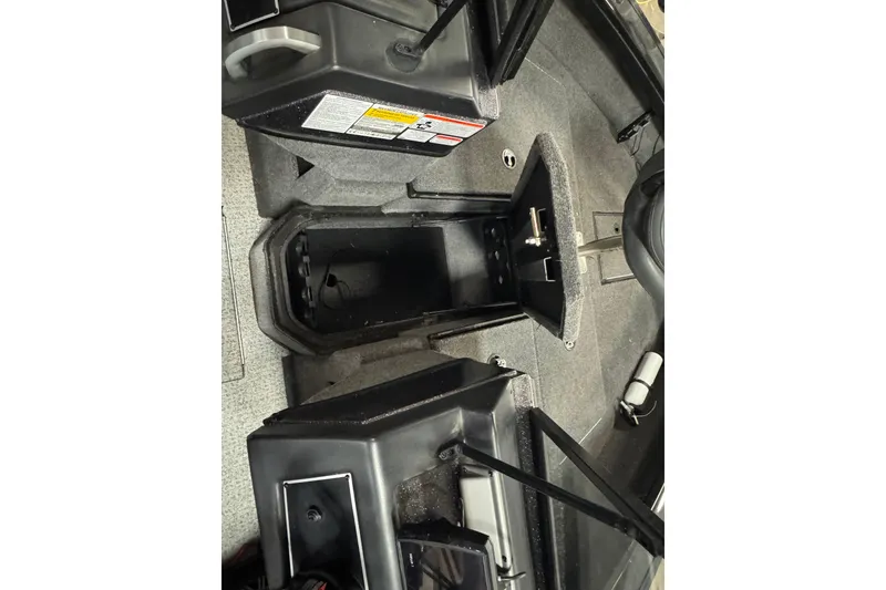 Slide: The Image of 2023 Ranger VX1888 WT boat interior with gray and red seat, control panel, and carpeted floor. - 17