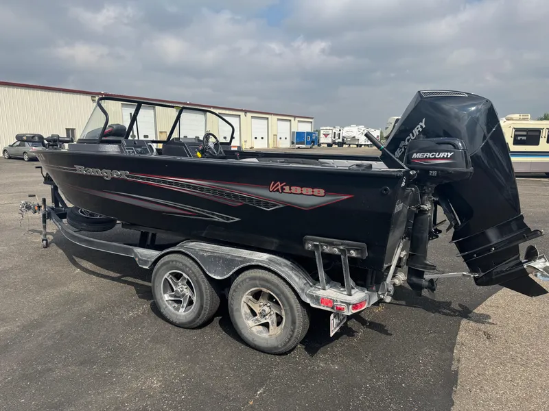Slide: The Image of 2023 Ranger VX1888 WT boat with Mercury outboard motor in a garage setting. - 4