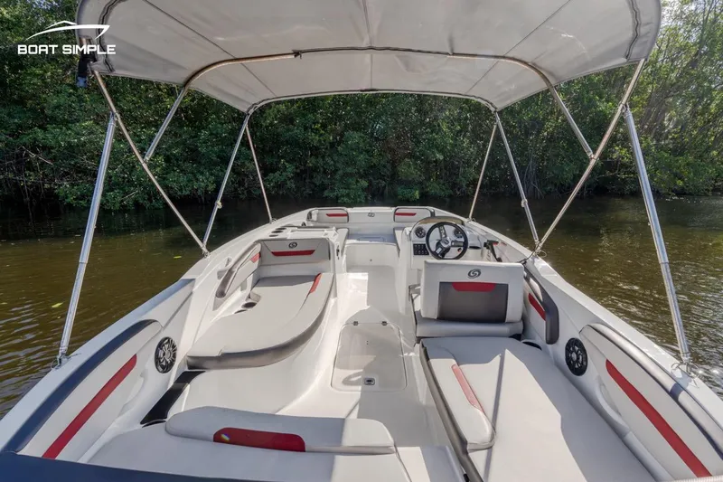 Slide: The Image of 2023 Hurricane SunDeck Sport 205 OB boat with canopy on calm water. - 6