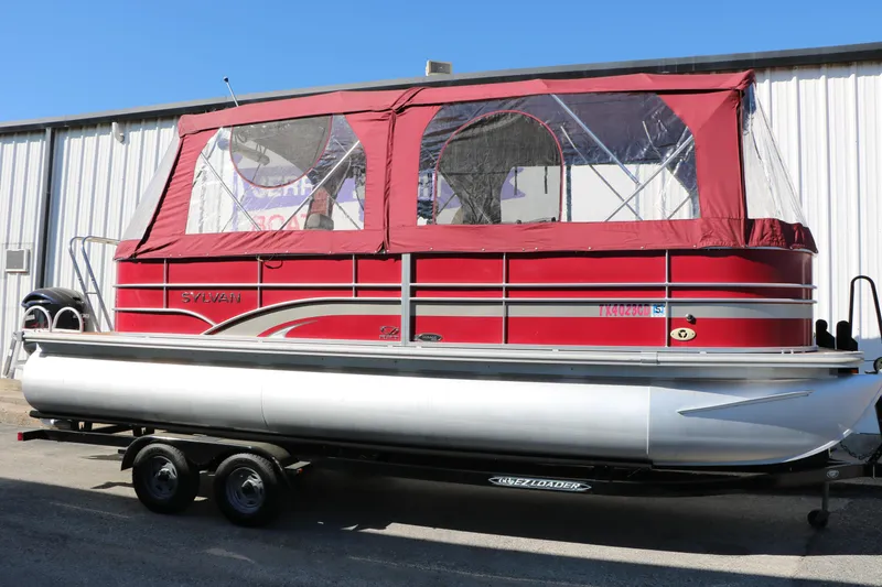 The Image of 2013 Sylvan Mirage 8522 pontoon boat with red canopy on trailer. - 0