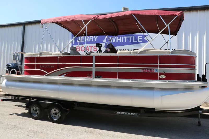 Slide: The Image of 2013 Sylvan Mirage 8522 pontoon boat with red canopy on trailer. - 1