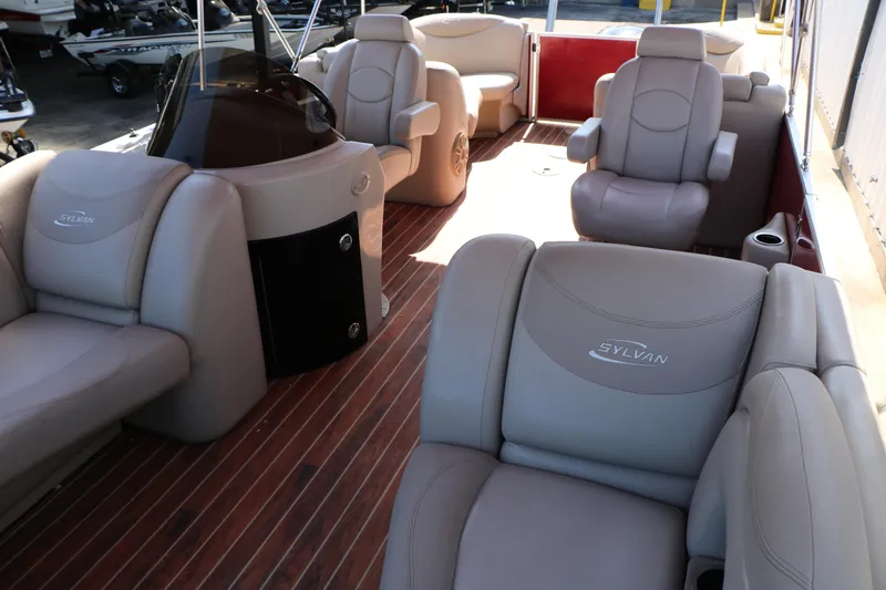 Slide: The Image of 2013 Sylvan Mirage 8522 boat with Yamaha 200 engine, red exterior, docked near a building. - 11