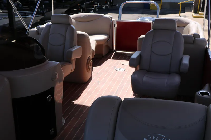 Slide: The Image of 2013 Sylvan Mirage 8522 boat interior with plush seating and wood flooring. - 13