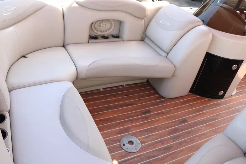 Slide: The Image of Luxurious interior of 2013 Sylvan Mirage 8522 pontoon boat with plush seating and wood flooring. - 14