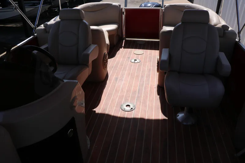 Slide: The Image of 2013 Sylvan Mirage 8522 boat interior with plush seating and wood-style flooring. - 15