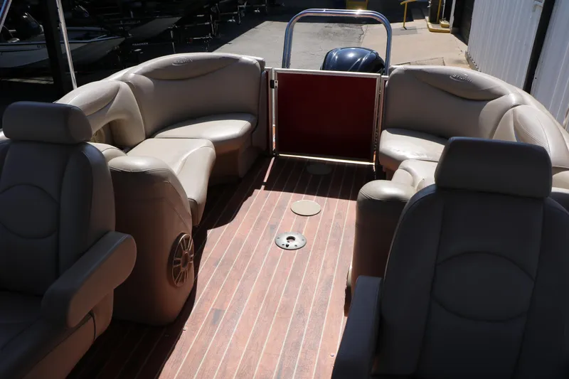 Slide: The Image of 2013 Sylvan Mirage 8522 boat interior with beige seating and wood flooring. - 16