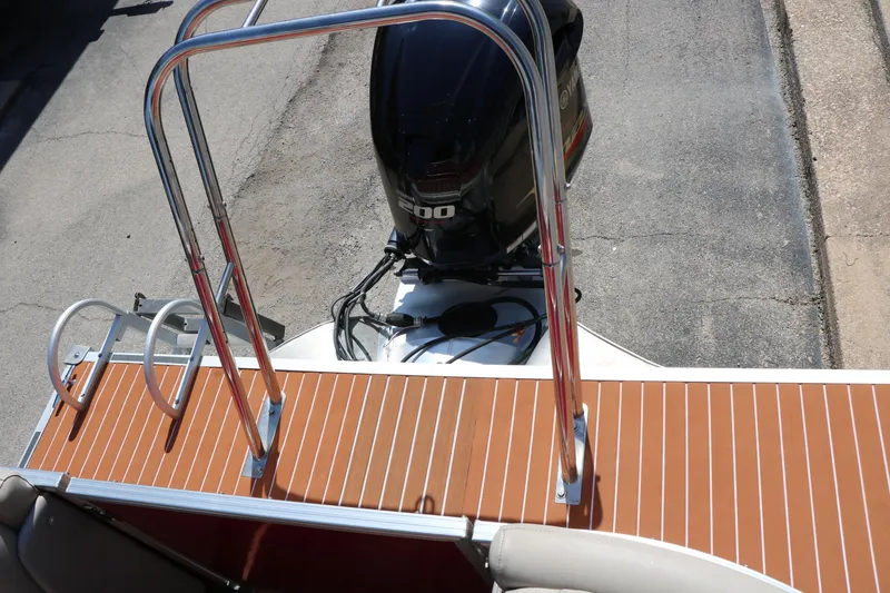 Slide: The Image of 2013 Sylvan Mirage 8522 boat interior with beige seating and wood-style flooring. - 18