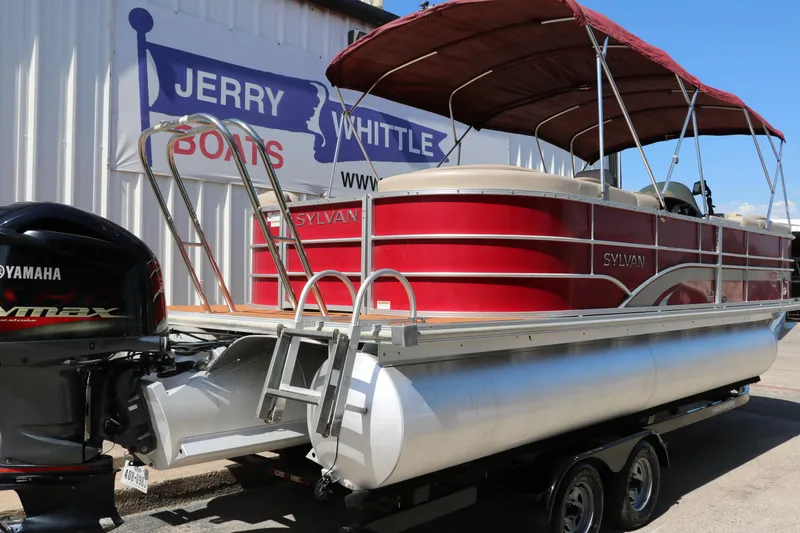 Slide: The Image of 2013 Sylvan Mirage 8522 pontoon boat with red canopy on trailer. - 2