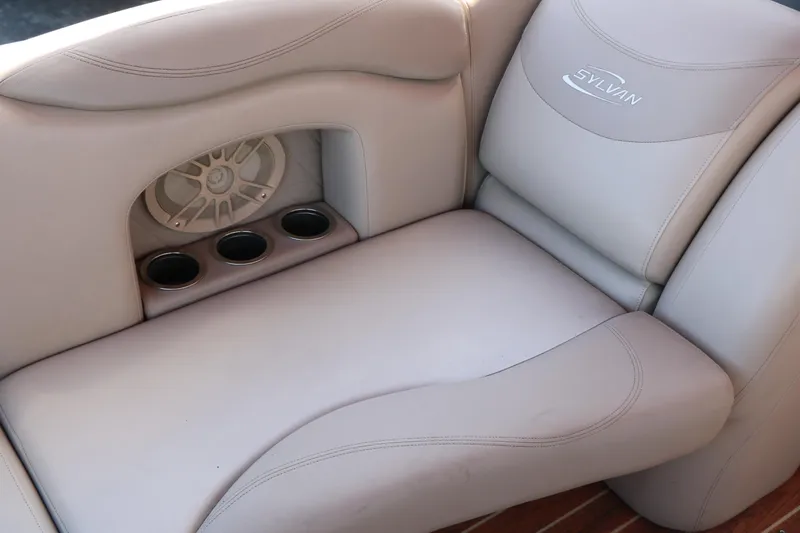 Slide: The Image of 2013 Sylvan Mirage 8522 boat interior with beige seating and wood-style flooring. - 29