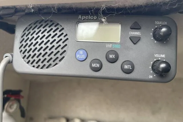 Slide: The Image of VHF radio on 1997 Grady-White Journey 258 boat, featuring Apelco VHF 5160 model. - 16