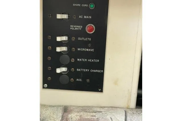 Slide: The Image of Electrical panel of 1997 Grady-White Journey 258 boat with various switches. - 21
