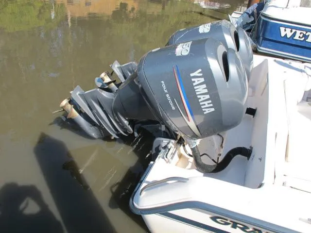 Slide: The Image of Twin Yamaha outboard engines on a 1997 Grady-White 258 Journey boat. - 24