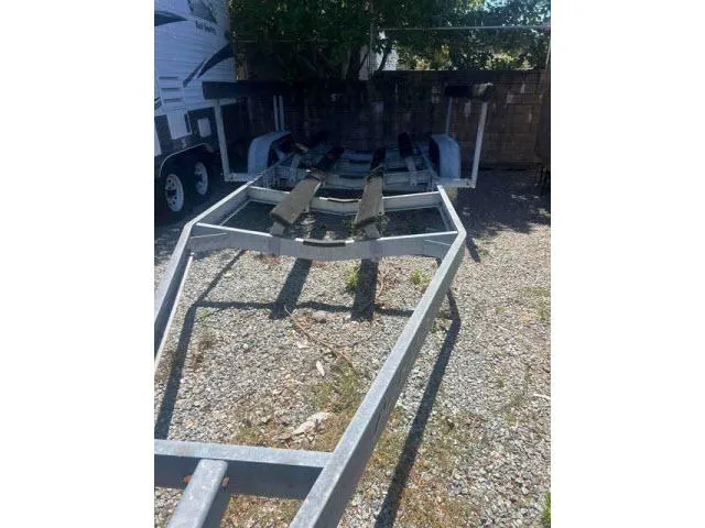 Slide: The Image of Trailer for 1997 Grady-White 258 Journey boat on gravel surface. - 25