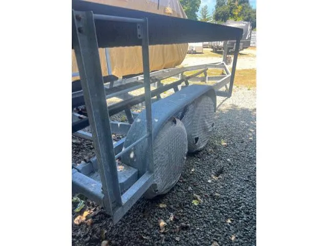 Slide: The Image of Trailer for 1997 Grady-White 258 Journey boat on gravel surface. - 28