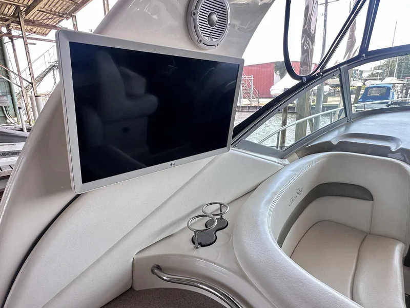 Slide: The Image of 2007 Sea Ray 320 Sundancer interior with TV and cup holders. - 12