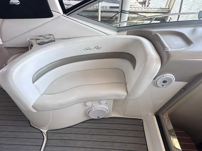 Slide: The Image of Luxury seating on 2007 Sea Ray 320 Sundancer boat, featuring white upholstery and integrated speakers. - 13