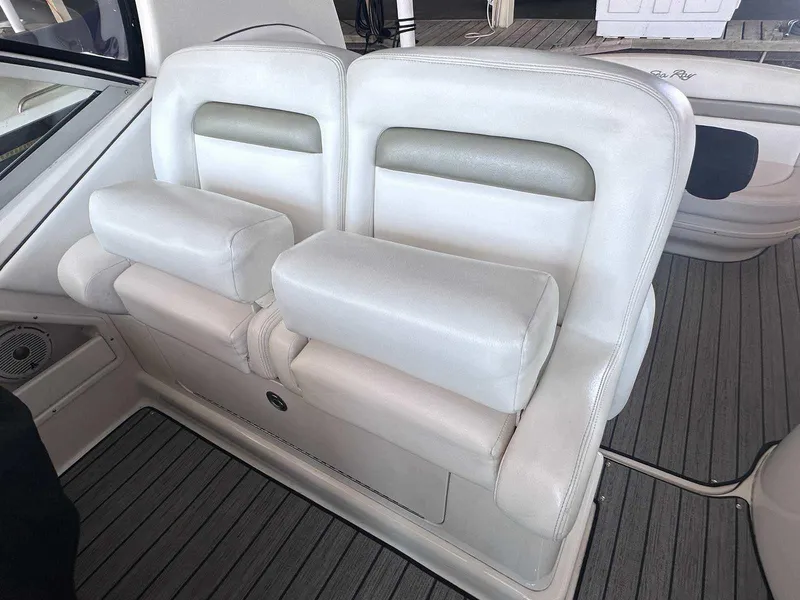 Slide: The Image of 2007 Sea Ray 320 Sundancer interior with white cushioned seating and sleek design. - 15